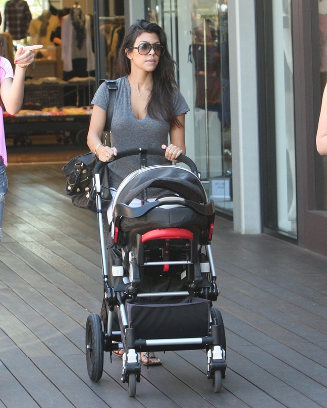 Kourtney Kardashian, flip flops, gray t-shirt, sunglasses, stroller, black purse
